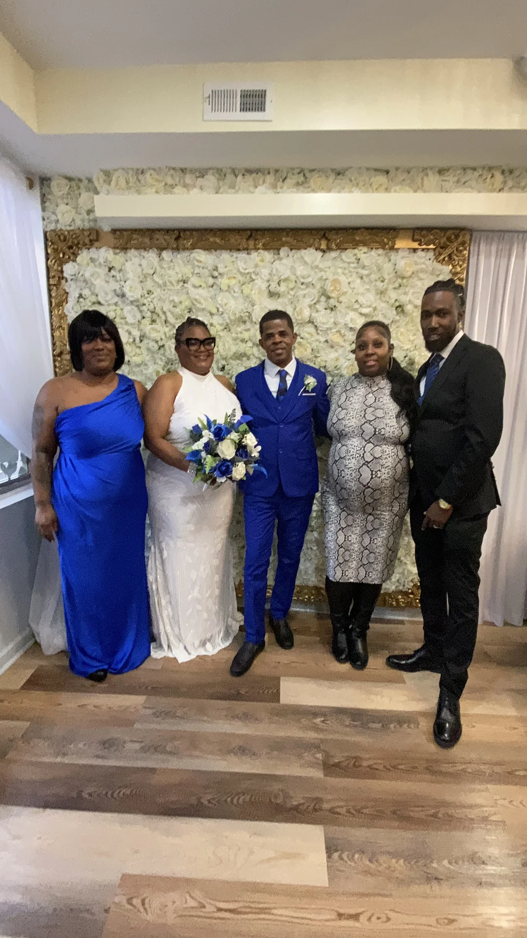 Wedding party at the flower wall