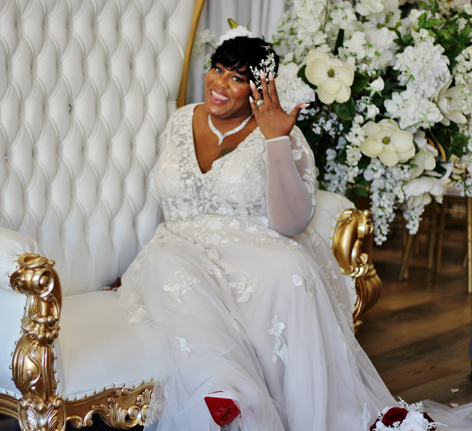 Bride showing her ring on the throne chair